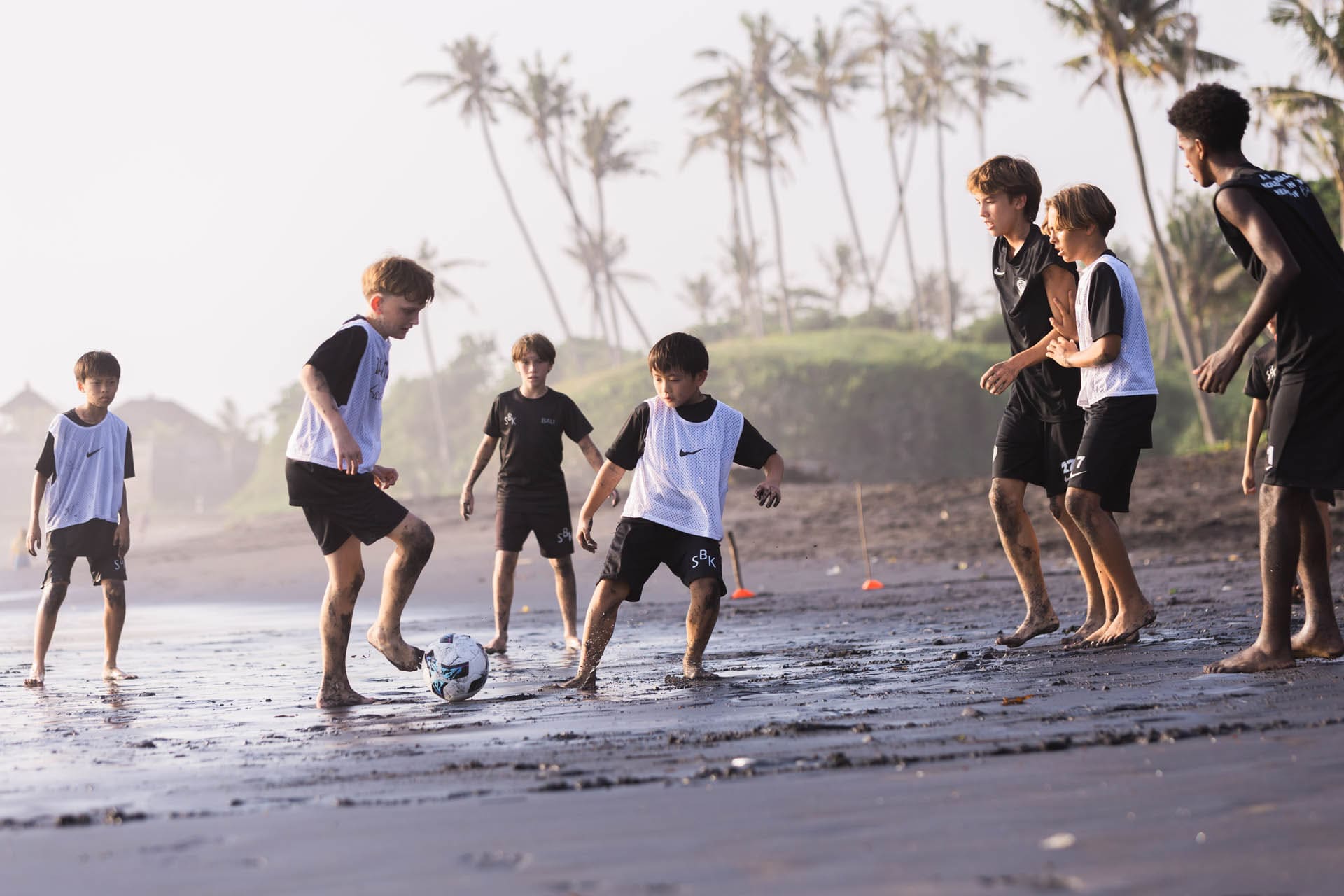 Image of junior football players on beach in Bali