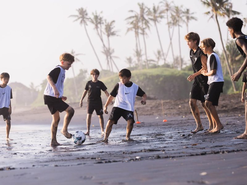 Image of junior football players on beach in Bali